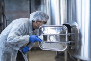 mujer trabajando en la limpieza de la industria alimentaria